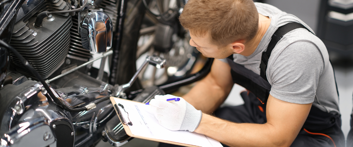 Motorcycle owner looking over motorcycle parts.